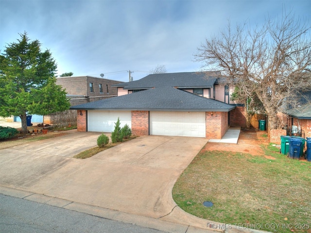 view of front of house with driveway, brick siding, roof with shingles, and an attached garage