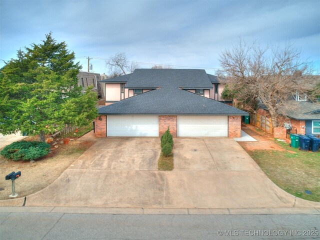 view of front of house featuring a garage, brick siding, roof with shingles, and driveway