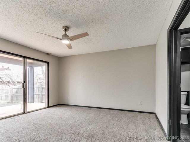 carpeted spare room featuring a textured ceiling, baseboards, and ceiling fan