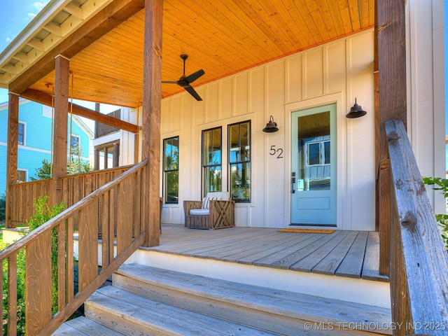 doorway to property with board and batten siding and ceiling fan