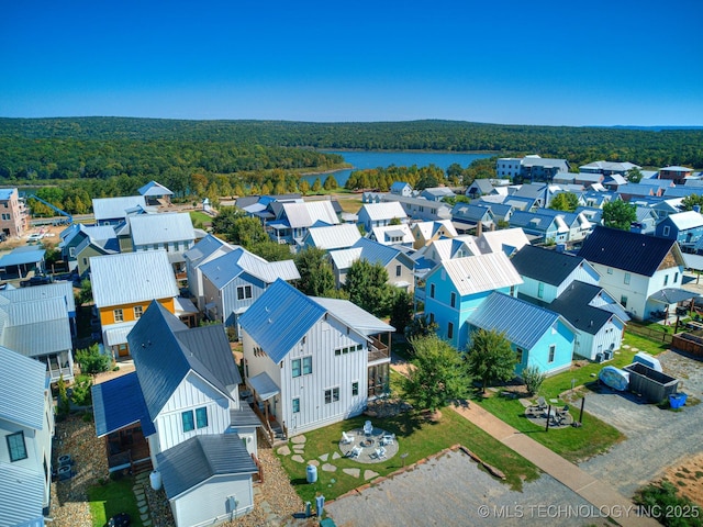 aerial view with a residential view, a water view, and a wooded view