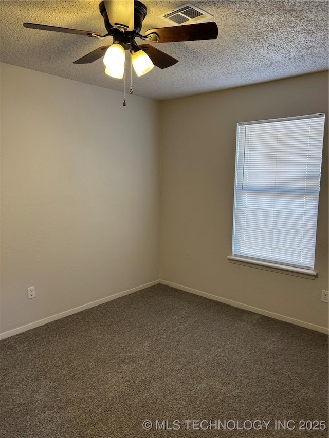 carpeted empty room featuring baseboards, visible vents, a textured ceiling, and ceiling fan