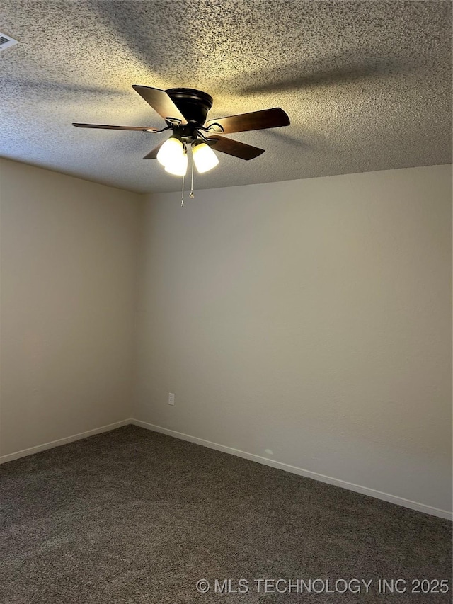 unfurnished room with dark colored carpet, baseboards, a textured ceiling, and ceiling fan