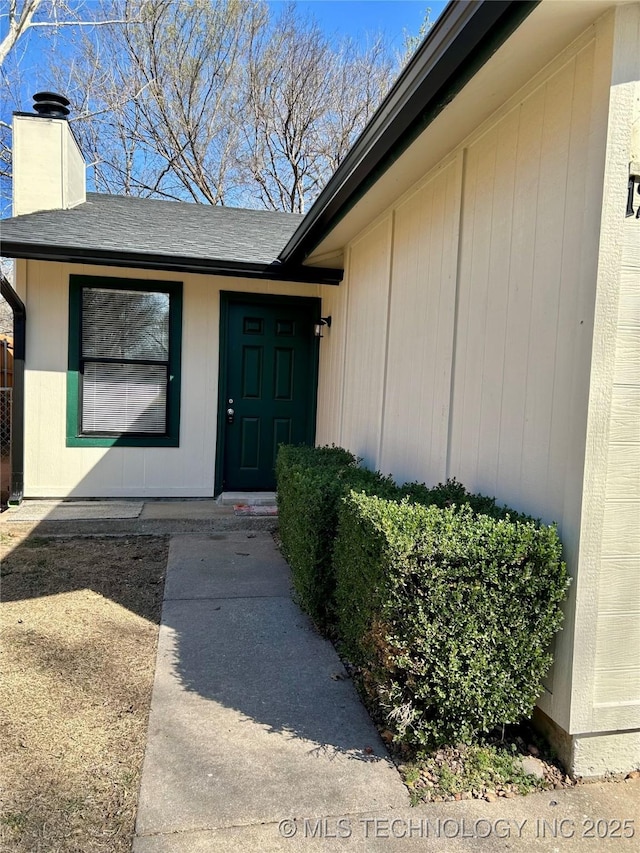 entrance to property with a chimney