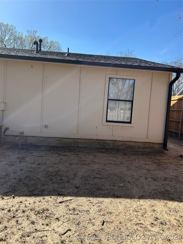 view of side of home with fence