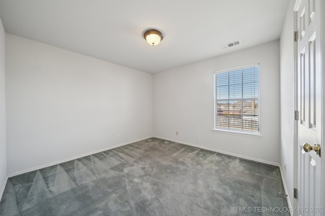 empty room with carpet flooring, baseboards, and visible vents