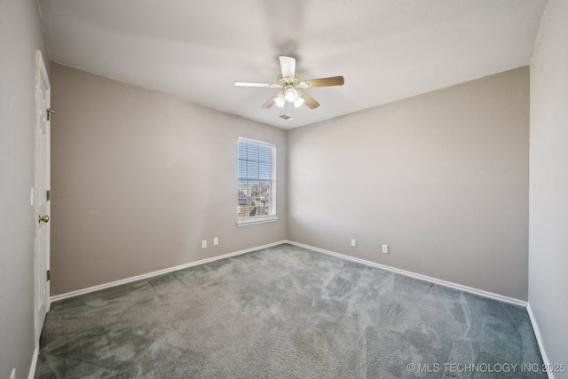 spare room with visible vents, baseboards, carpet floors, and ceiling fan