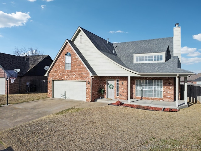 traditional-style home with a front yard, fence, driveway, a chimney, and brick siding