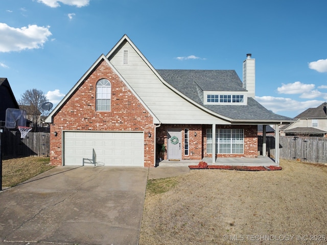 traditional-style house with brick siding, fence, a garage, and driveway