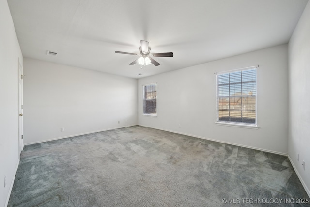 unfurnished room with visible vents, baseboards, carpet, and a ceiling fan