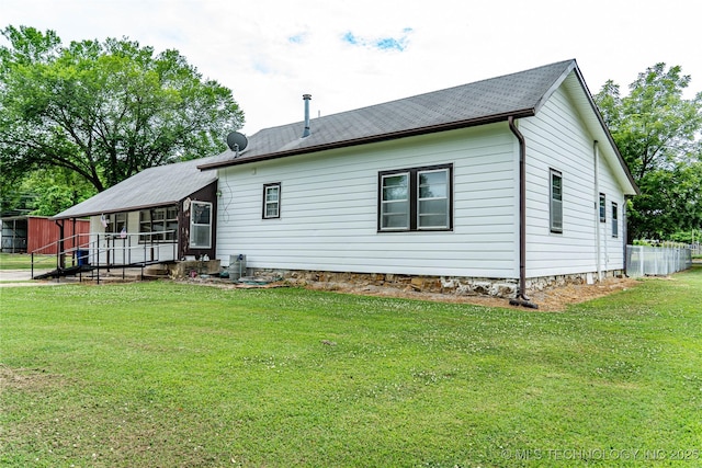 rear view of property with a lawn