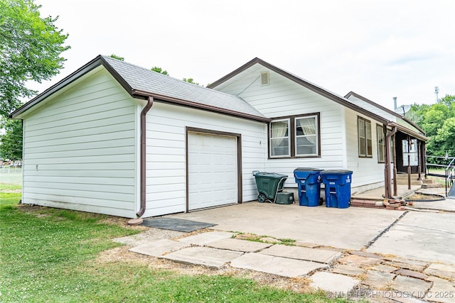 view of home's exterior featuring driveway, a lawn, and an attached garage