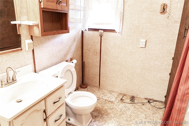 half bath featuring toilet and vanity