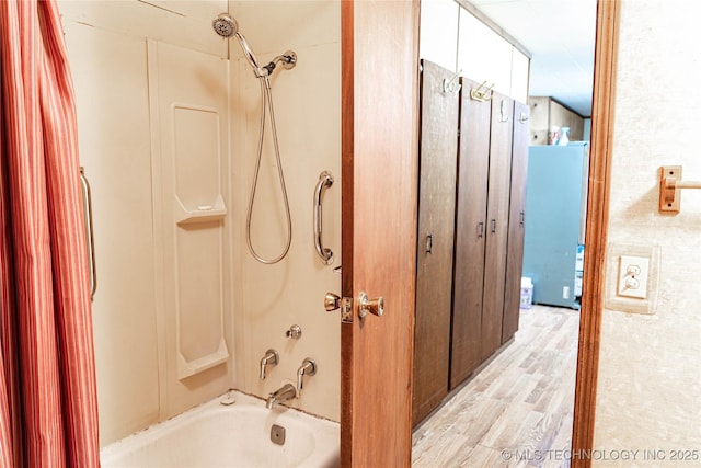 bathroom with bathtub / shower combination and wood finished floors