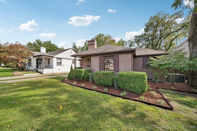 ranch-style house with a front yard, a chimney, brick siding, and a shingled roof