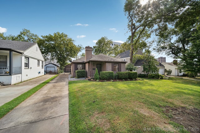 view of front of home featuring a front yard, a chimney, and driveway