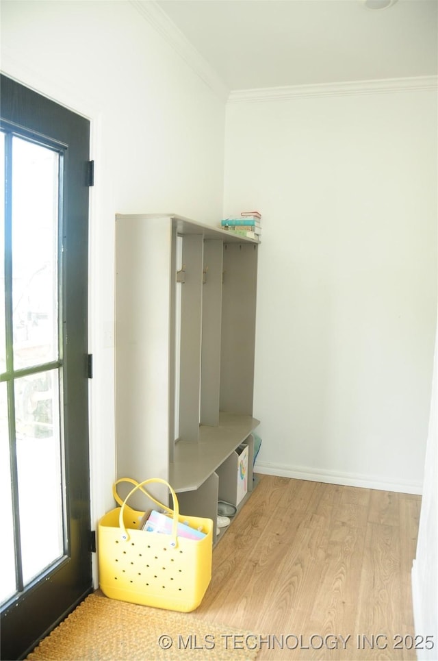 mudroom with crown molding, baseboards, a healthy amount of sunlight, and wood finished floors