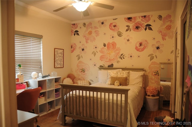 bedroom featuring ceiling fan, ornamental molding, wallpapered walls, and wood finished floors