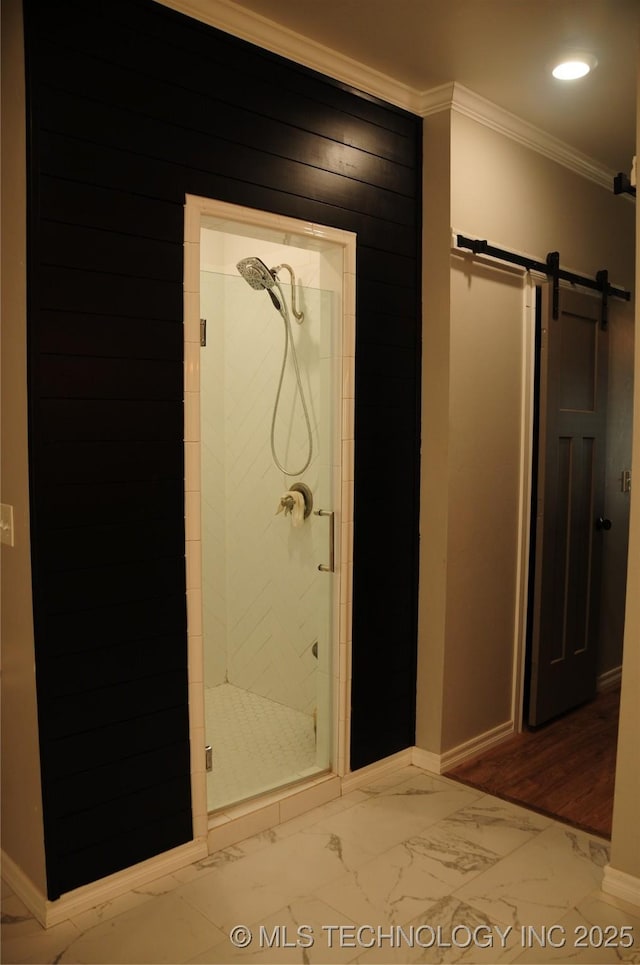 bathroom with crown molding, baseboards, a shower stall, and marble finish floor