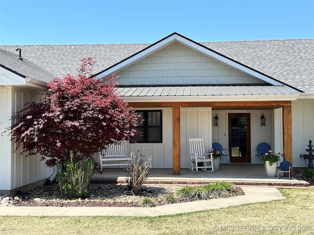 view of front of property with roof with shingles and a porch