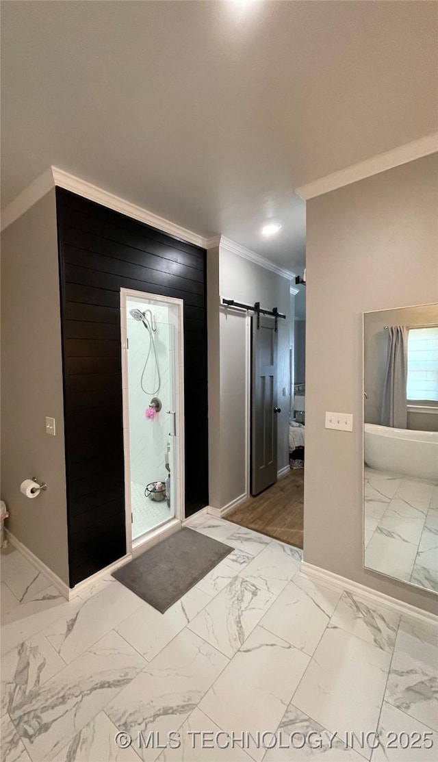 foyer entrance featuring crown molding, baseboards, a barn door, and marble finish floor