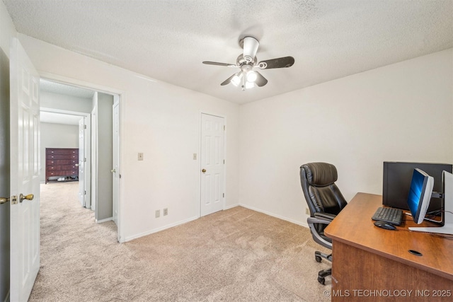 office area with baseboards, a ceiling fan, carpet flooring, and a textured ceiling