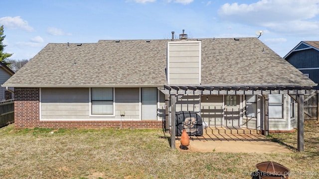 rear view of house featuring a patio, a pergola, a shingled roof, a lawn, and brick siding