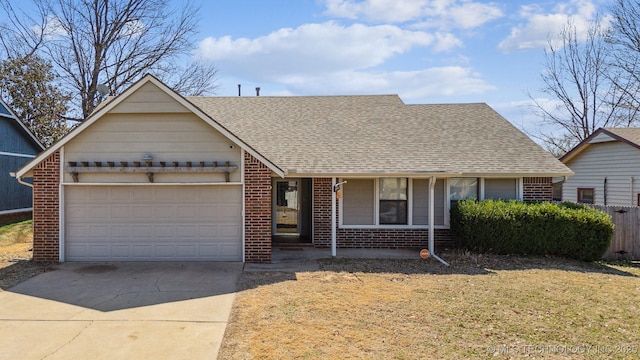 view of front of property with brick siding, concrete driveway, and a shingled roof