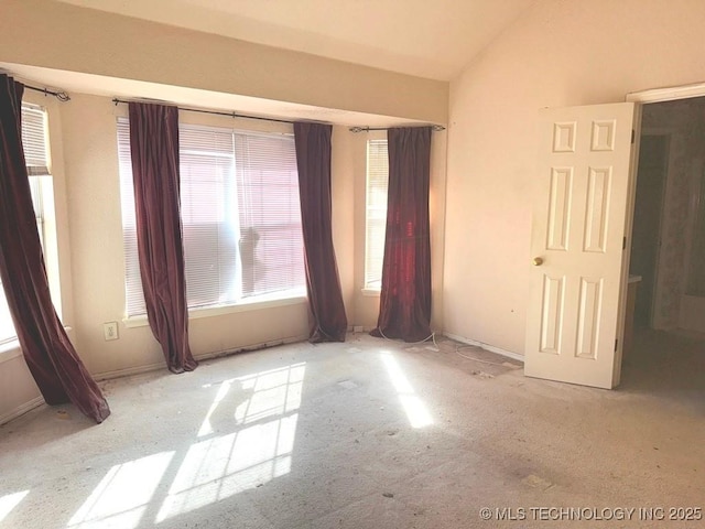 unfurnished bedroom with lofted ceiling