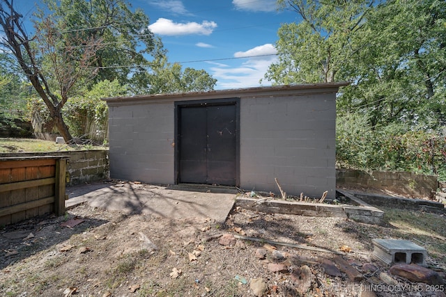 view of shed featuring fence