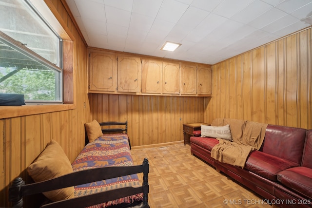 living area featuring wood walls