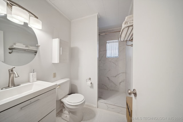 bathroom with vanity, toilet, marble finish floor, and a marble finish shower