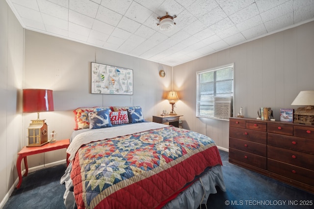 bedroom with baseboards and carpet floors