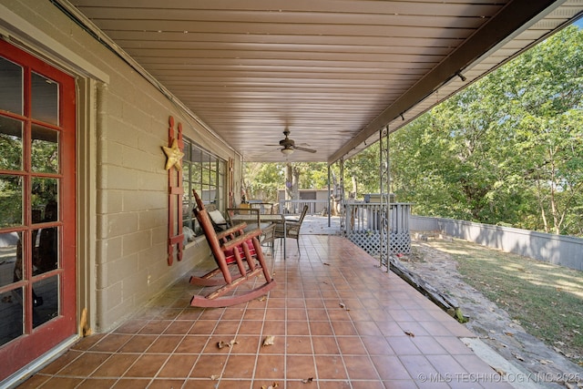 view of patio / terrace with a porch, ceiling fan, and fence