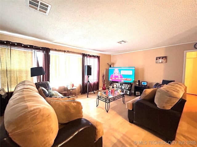 living room featuring visible vents and a textured ceiling