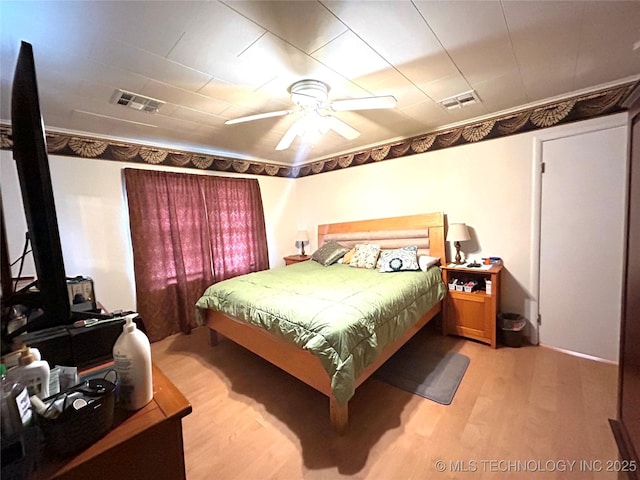 bedroom with visible vents, light wood-type flooring, and ceiling fan