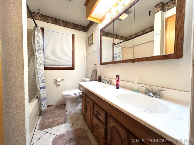 bathroom with tile patterned floors, toilet, double vanity, and a sink