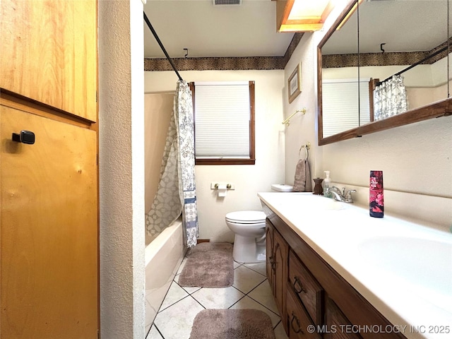 full bathroom featuring tile patterned flooring, double vanity, toilet, and a sink