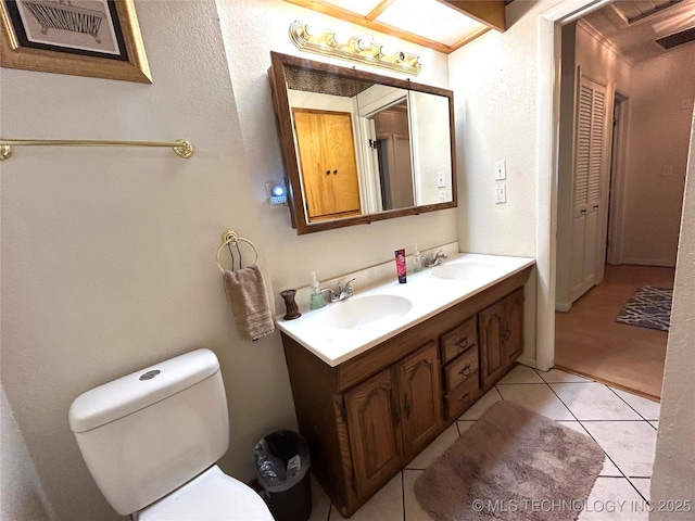 bathroom with a sink, visible vents, toilet, and double vanity