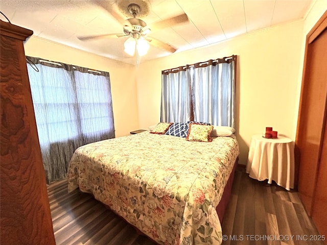 bedroom featuring dark wood-style floors and a ceiling fan