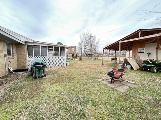 view of yard featuring a sunroom