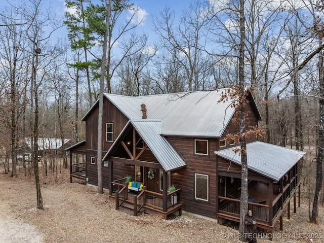 rear view of property with metal roof