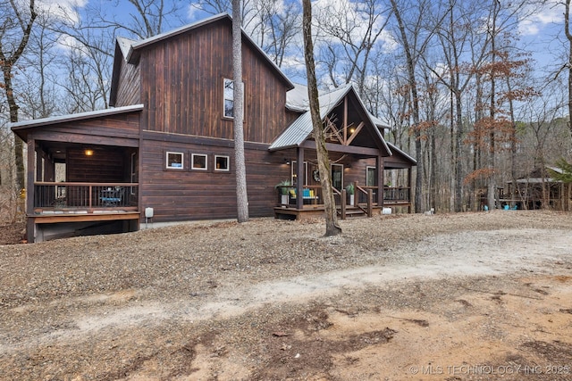 exterior space featuring a porch and metal roof