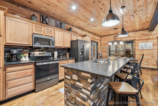 kitchen with light wood finished floors, a sink, light brown cabinetry, appliances with stainless steel finishes, and wooden ceiling