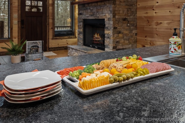 room details with a fireplace and wood walls