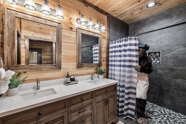 bathroom featuring a sink, wooden ceiling, double vanity, and a tile shower