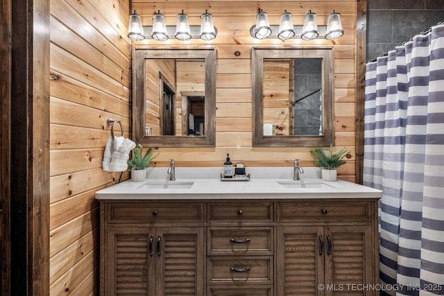 full bathroom featuring wood walls and a sink