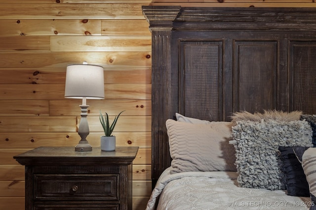 bedroom featuring wood walls