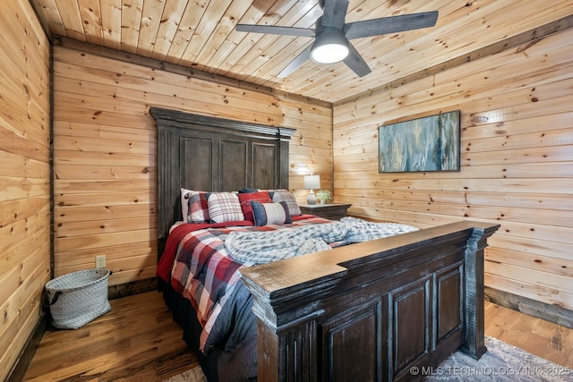 bedroom featuring wood ceiling, wood walls, and dark wood-style flooring