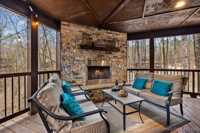 wooden deck featuring an outdoor living space with a fireplace